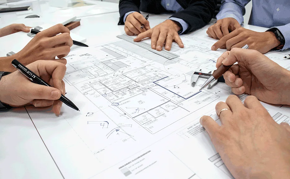 Design team reviewing technical plans