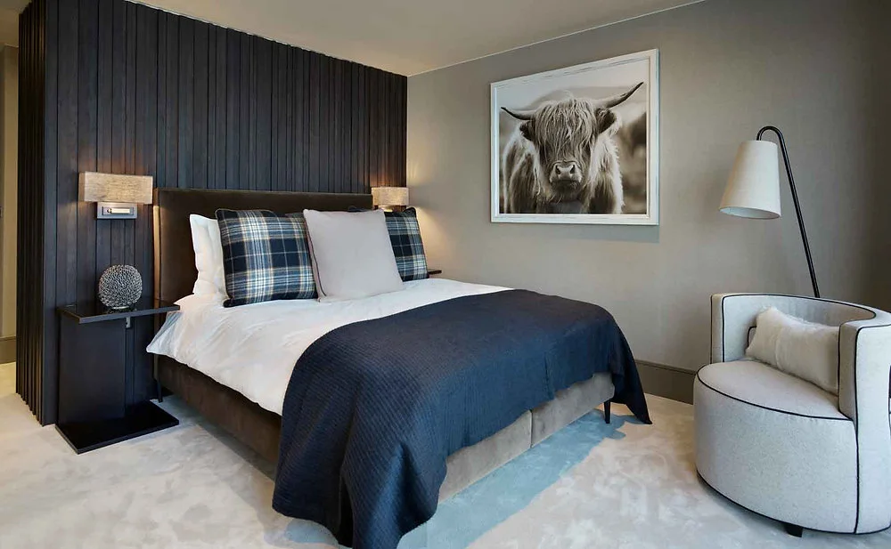 Bedroom with coordinated curtains and bedside lighting