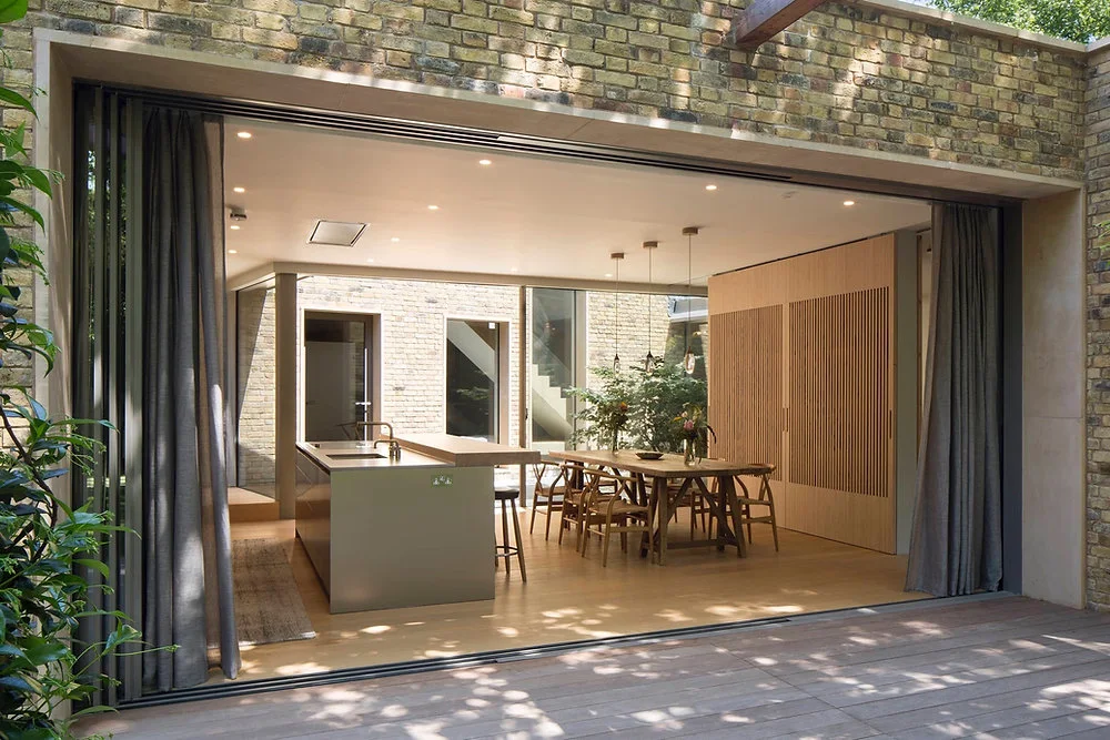 Open-plan kitchen opening onto a garden