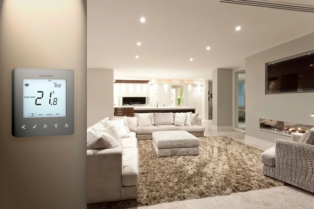 Heatmiser wall thermostat beside a living area